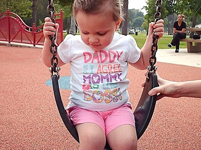 a child sitting on a swing